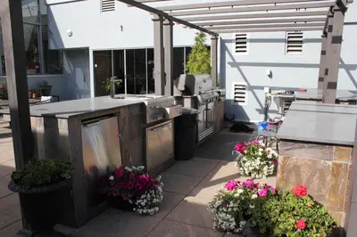 an outdoor kitchen with flowers on a patio at Your Vacation Home Downtown Vancouver in Vancouver