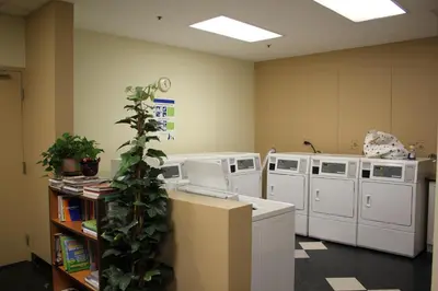 an office with four washing machines and a plant at Your Vacation Home Downtown Vancouver in Vancouver
