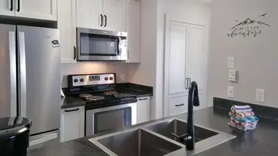 a kitchen with a sink and a stove top oven at Crystal Forest #29 by Bear Country in Sun Peaks