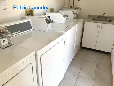 a kitchen with white cabinets and a sink at Duncan Motel in Duncan