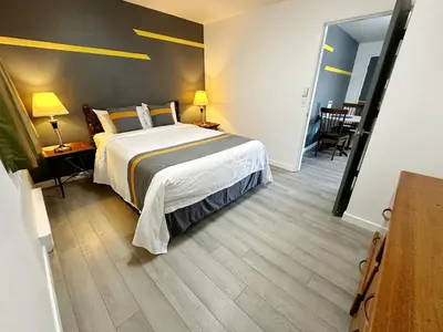 a bedroom with a bed and a table and chairs at Duncan Motel in Duncan