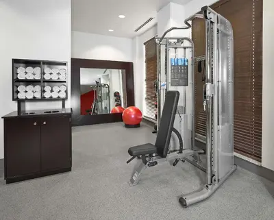 a room with a gym with a chair and a simulator at Hampton Inn by Hilton Calgary Airport North in Calgary