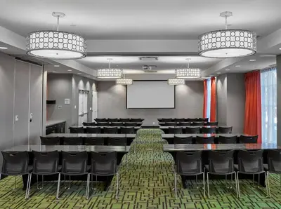 a conference room with chairs and a projection screen at Hampton Inn by Hilton Calgary Airport North in Calgary