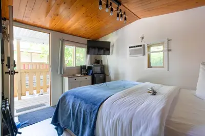 a bedroom with a large bed and a window at The Valley View Cabins and Event Center in Creston