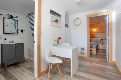 a room with a white desk and a bathroom at The Valley View Cabins and Event Center in Creston