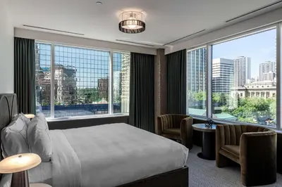 a bedroom with a bed and a large window at The Westley Calgary Downtown, Tapestry Collection By Hilton in Calgary