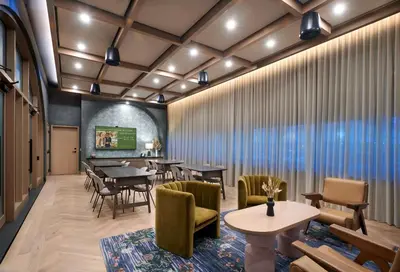a restaurant with tables and chairs in a room at The Westley Calgary Downtown, Tapestry Collection By Hilton in Calgary
