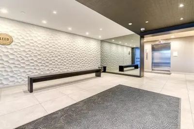 an office lobby with a bench and a door at Kensington Suite 2bed & 1bath in Calgary