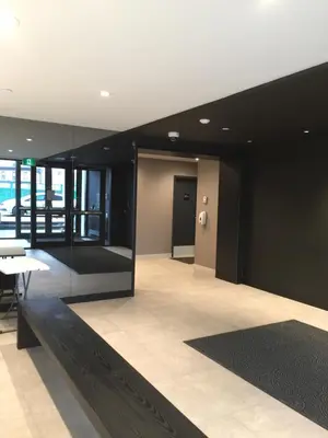 a lobby with a black wall and a white table and chairs at Kensington Suite 2bed & 1bath in Calgary