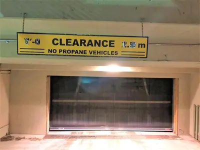 a sign above a garage with a no propane vehicles sign at Windtower Lodge Queen Bed Suite-UGParking&Walking2DT in Canmore