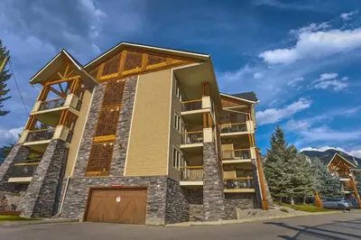 a tall building with a garage at Sable Ridge Condos by StayIn in Radium Hot Springs