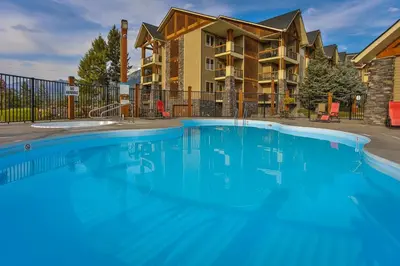 a swimming pool in front of a apartment building at Sable Ridge Condos by StayIn in Radium Hot Springs