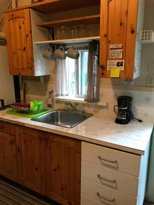 a kitchen counter with a sink and a window at Holiday Lodge Cabins in Banff
