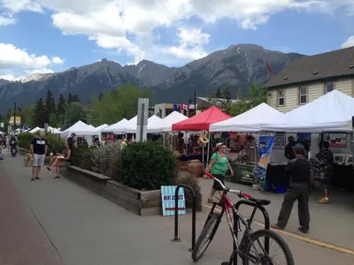 a bike parked in front of a market with tents at Apartment 406, Indigenous Artefacts in Canmore