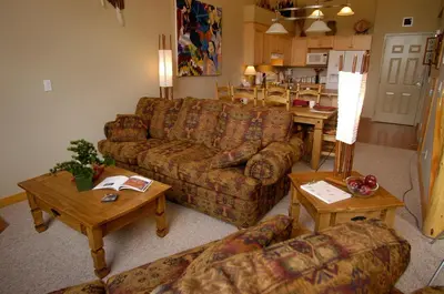 a living room with a couch and a table at Apartment 406, Indigenous Artefacts in Canmore