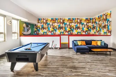 a living room with a pool table and a couch at Delta Hotels by Marriott Grande Prairie Airport in Grande Prairie