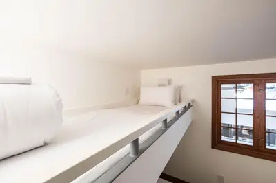 a room with two beds and a window at Snowberry by Outpost Whistler in Whistler