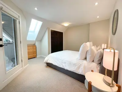 a bedroom with a bed and a window at 3BR in Gleneagle, Ski Storage, Wood Burning Fireplace, Free Shuttle in Whistler