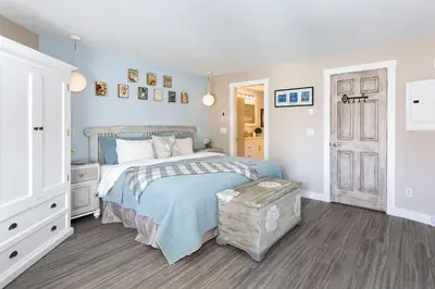 a bedroom with a bed with a blue comforter at Renovated & Spacious 1bed/2bath Whistler Village in Whistler