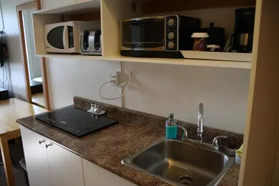 a kitchen counter with a sink and a microwave at CHINOOK INN in Rocky Mountain House