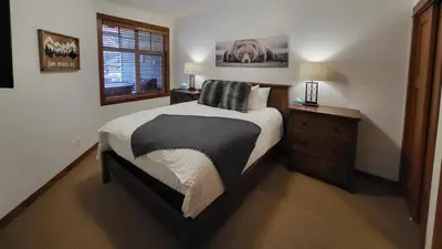 a bedroom with a large bed and a window at Settlers Crossing #41 by Bear Country in Sun Peaks