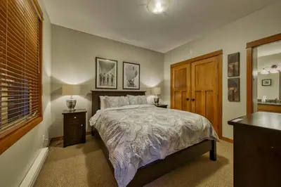 a bedroom with a large bed and a window at Settlers Crossing #08 by Bear Country in Sun Peaks