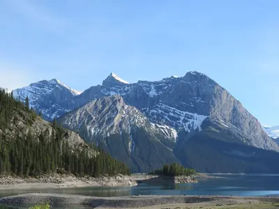 a mountain range with a lake in the foreground at Apartment 411, Antique Heritage in Canmore