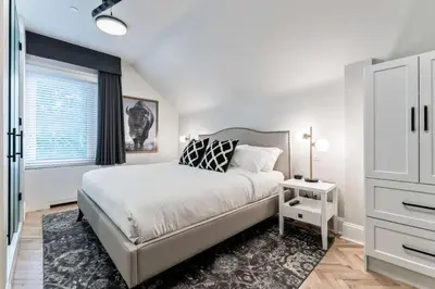 a bedroom with a large bed and a window at The Inn on Officers' Garden in Calgary