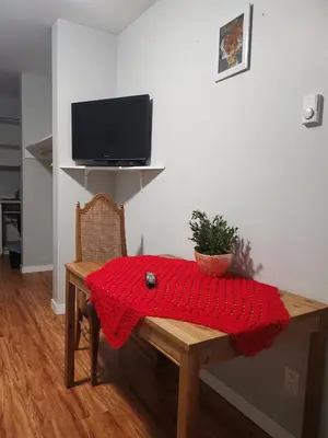 a red blanket on a wooden table in a room at Coquihalla Motel in Hope