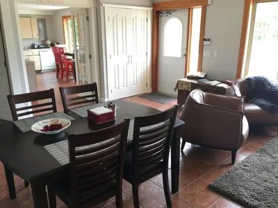 a dining room and living room with a table and chairs at All Seasons Bed & Breakfast in Kelowna