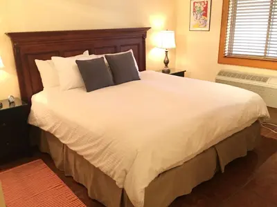 a bedroom with a large white bed with two pillows at All Seasons Bed & Breakfast in Kelowna