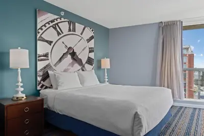 a hotel room with a large clock on the wall at WorldMark Victoria in Victoria