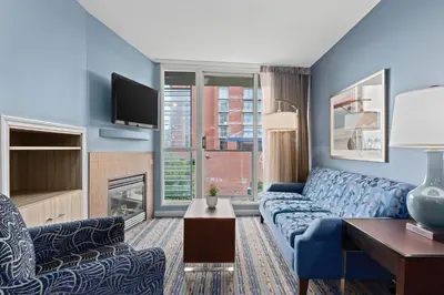 a living room with a blue couch and a tv at WorldMark Victoria in Victoria