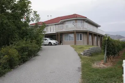 a house with a car parked in the driveway at Sonora Desert Inn in Osoyoos