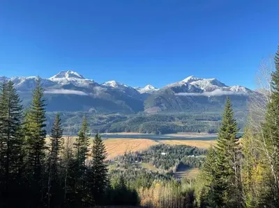 a view of a valley with snow capped mountains at Lily glacier suite at silver bear condos in Revelstoke