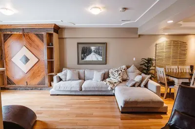 a living room with a couch and a table at The Watermark Suite - Downtown in Drumheller