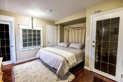a bedroom with a bed and a window at The River Blossom Suite - Downtown in Drumheller
