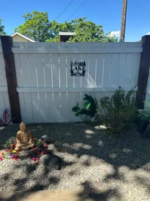 a white fence with a sign that says make a take at K STREET CARRIAGE HOUSE Studio in Penticton