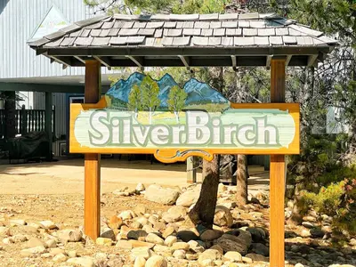 a sign for a silver bluff with a roof at Silver Birch by StayIn in Kimberley