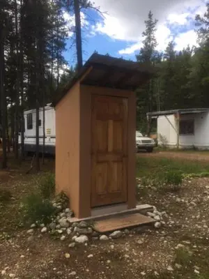 a small house with a door in a field at Jade Fever Cabina in Jade City