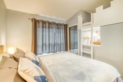 a bedroom with a bed and a large window at Beautiful Newly Reno 2BDM 2 Bth Sleep up to 6 Adults & Kids Mountain View Townhouse Suite in Canmore