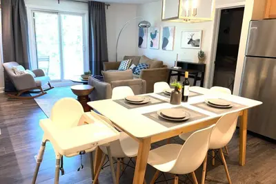 a kitchen and living room with a table and chairs at Cozy 2 BR - King and Queen Condo Sleep up to 6 for WFH & Vacation in Canmore
