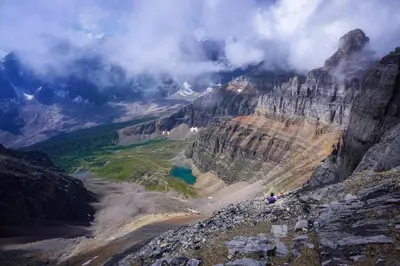 a person standing on top of a mountain at Cozy 2 BR - King and Queen Condo Sleep up to 6 for WFH & Vacation in Canmore