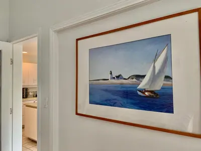 a painting of a sailboat on the water in a kitchen at One Bedroom queen bed Sharing Washroom in Tiger Sweet House License## in Richmond