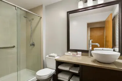 a bathroom with a toilet and a sink and a shower at Days Inn by Wyndham Vancouver Downtown in Vancouver