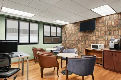 a conference room with tables and chairs and a tv at Days Inn by Wyndham Vancouver Downtown in Vancouver
