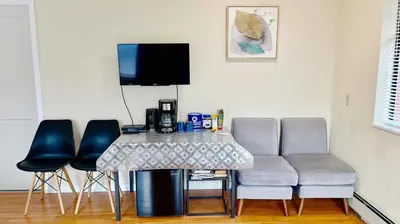 a table and chairs in a room with a couch at Private Suite with Separated Entrance Monica's Home in Richmond