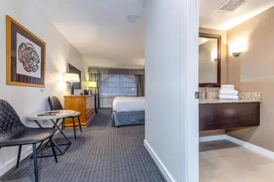 a hotel room with a bed and a bathroom at Listel Whistler, a Coast Hotel in Whistler