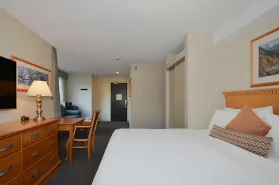 a hotel room with a bed and a desk at Listel Whistler, a Coast Hotel in Whistler