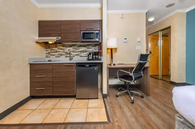 a kitchen with a desk and a chair in a room at Grand Park Hotel & Suites Downtown Vancouver, an Ascend Collection Hotel in Vancouver